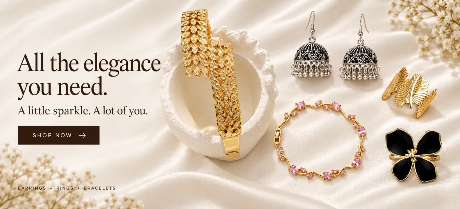 A little sparkle. A lot of you. Gold bracelets, silver jhumka earrings and gold rings on ivory silk. Earrings, rings, bracelets.
